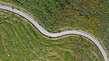 Fototapeta premium Aerial drone top view photo of serpentine snake curve road in green mountain with beautiful nature