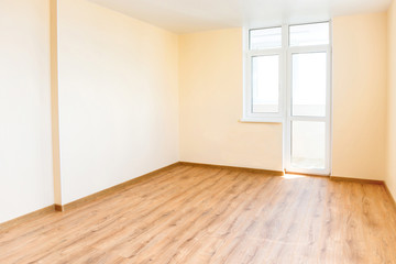 Living room interior of empty room with wooden floor and light from the big window