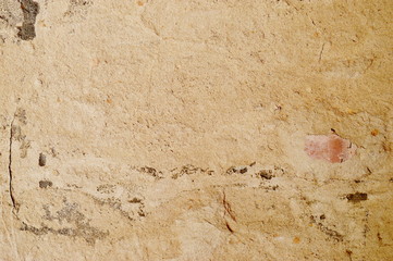 Plastered wall with sand texture. Lighting from above