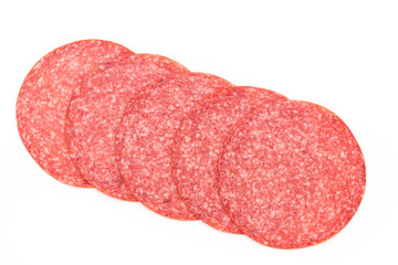 Salami slices on white background.