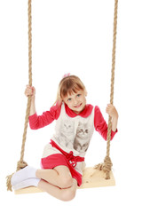 Little girl swinging on a swing