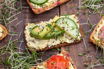 Sandwiches with cream cheese, vegetables and salami.
