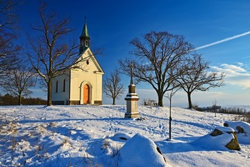 Fototapeta na wymiar Beautiful winter landscape photo with church. Sunny winter day. Brno - Líšeò. Chapel of Our Lady of Helper.