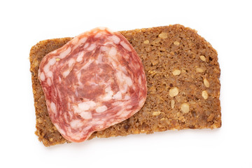 Salami slices on white background.