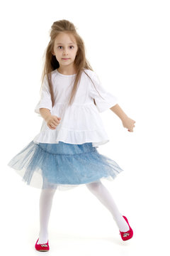 A cheerful little girl is dancing.