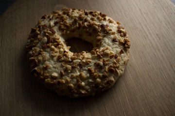 Whole grain cereal shortbread biscuits cookies stacked with nuts. Wooden background