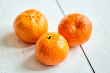 Tangerine fruits on a white wooden table