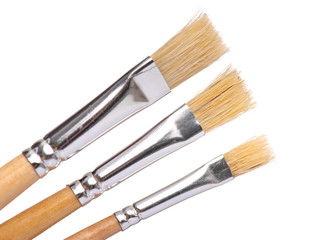 Set of three New wooden artist painting brushes, isolated on white background 