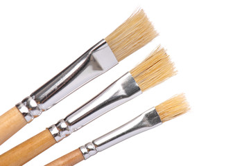 Fototapeta premium Set of three New wooden artist painting brushes, isolated on white background 