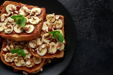 French cinnamon toast with banana, nuts and hazelnut, honey.