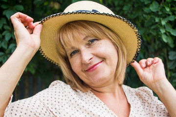 Portrait of beautiful blonde woman in hat