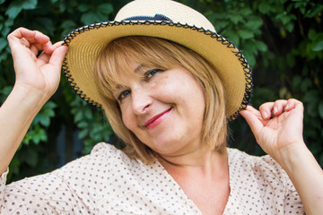 Portrait of beautiful blonde woman in hat