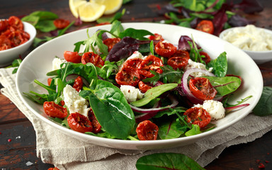 Sun dried tomatoes Salad with fresh vegetables mix and mozzarella cheese. healthy food