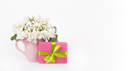White spring flowers and gift box. Gift and flowers on white background. Copy space