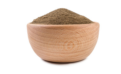 milled or ground black pepper in wooden bowl isolated on white background. Spices and food...