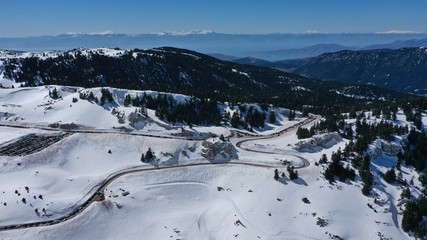 Aerial drone photo of popular winter ski destination in Swiss mountain covered up with snow