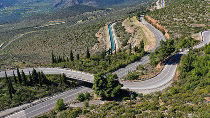Fototapeta na wymiar Aerial drone top view photo of snake curvy road built in steep mountain slope