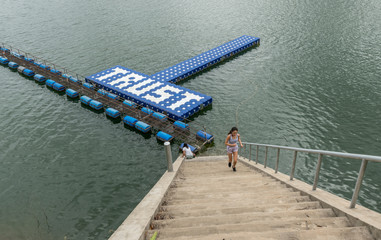 Teenager and mother at resevoir in Thailand