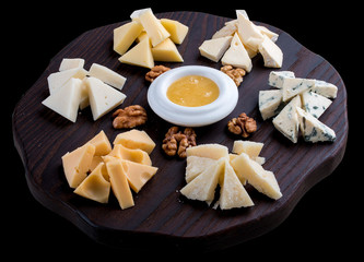 A set of different cheeses on a wooden Board. Cheese Board.