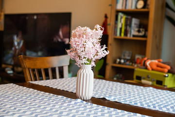 Pink  hyacinth blossom in a small pink vase