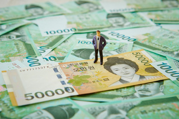 Korean won banknotes and miniature man