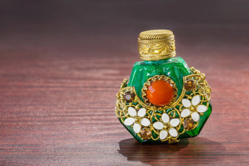Little oriental perfume bottle in green jade, with brown sinhalite gems and red carnelian stone,...