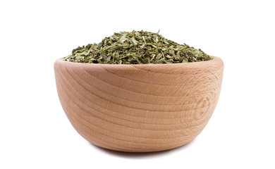 Fototapeta na wymiar tarragon herb in wooden bowl isolated on white background. Spices and food ingredients.