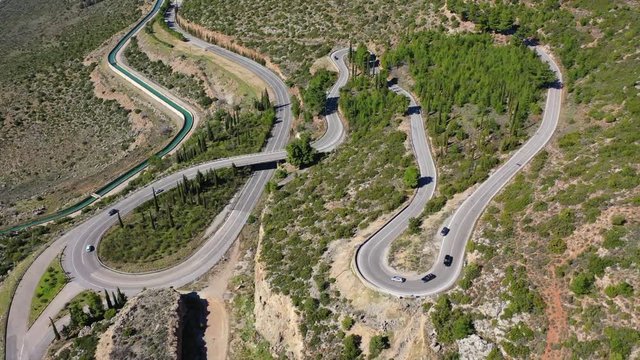 Aerial drone top view video of snake curvy road built in steep mountain slope