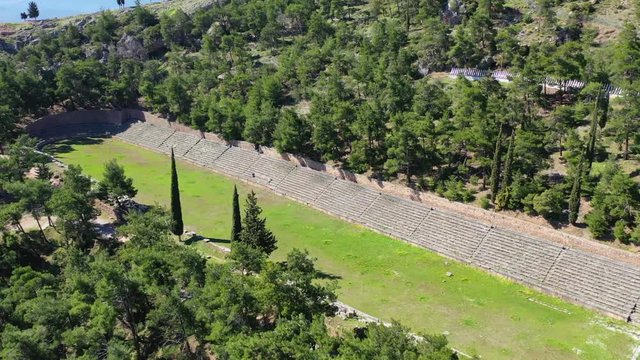 Aerial drone video of iconic Temple of Apollo in archaeological site of Delphi one of the most important of Ancient times, Voiotia, Greece
