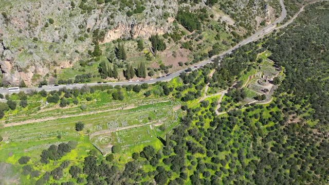 Aerial drone video of iconic Temple of Apollo in archaeological site of Delphi one of the most important of Ancient times, Voiotia, Greece