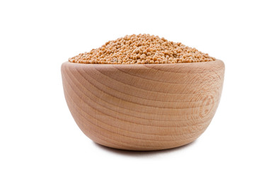 white mustard in wooden bowl isolated on white background. Spices and food ingredients.