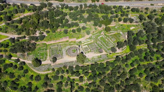 Aerial drone video of iconic Temple of Apollo in archaeological site of Delphi one of the most important of Ancient times, Voiotia, Greece