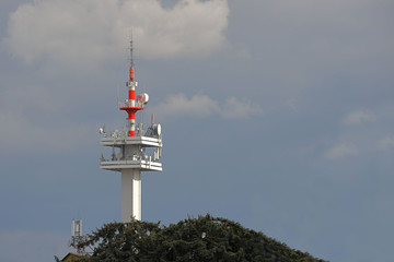 Radio tower with antennas on a blue sky background. Metal construction. Wireless network. Transmit tv radio signal. Egology of the environment. Information digitalization and high technology
