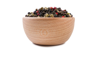colored pepper peppercorns in wooden bowl isolated on white background. Spices and food ingredients.