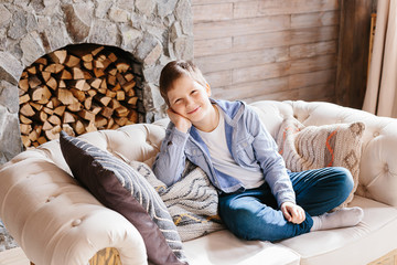 Portrait teenage caucasian boy sitting on couch at home