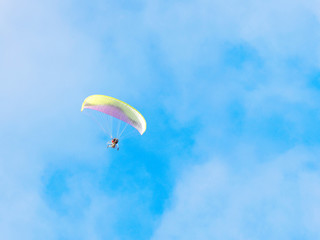 Moto paraglider, paramotor, blue sky, white clouds