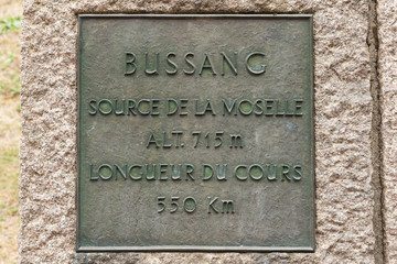 Fototapeta premium Bronze plate telling the altitude and length of the Moselle at its source on the Col de Bussang
