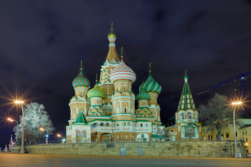 View on the illuminated Cathedral of Vasily the Blessed in Moscow, Russia, on the Red Square near the Kremlin in the cloudy night 
