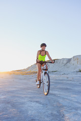 Fototapeta premium Young sporty woman with a bike, soft focus background