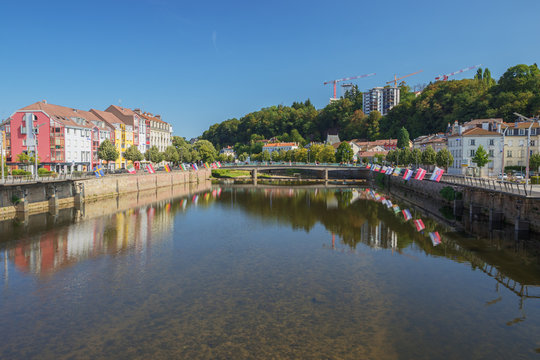 The Moselle in Epinal with flags on both shores