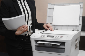 Bussinesswoman hand press button on panel of printer, printer scanner laser office copy machine...