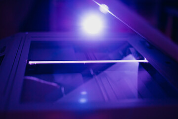 Copier scanner with a bright light inside. Office hazards concept: Photocopiers, laser, printers