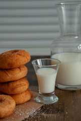 Close-up of donuts in stack with milk bottle and glass