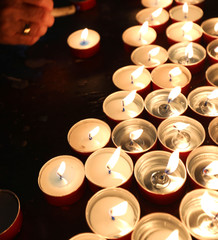 candles with flickering flame in the place of worship during the