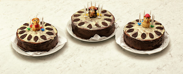 Three chocolate tarts with marchpane figures of puppies and bears