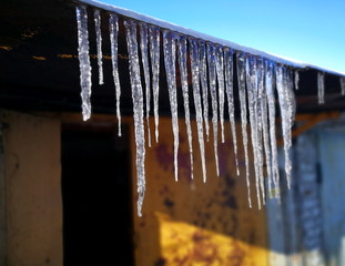 On the roof garage are hanging several long icicles.