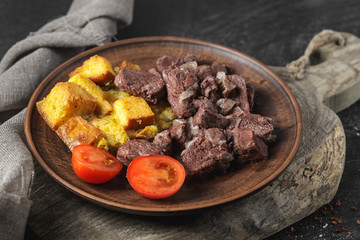 Baked beef with croutons, cherry tomatoes