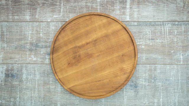 Stop motion of appearance of fresh pizza on a wooden table. Top view, 4K animation