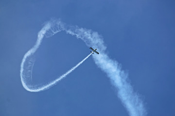 Airplane looping the loop with a vapour trail