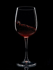 glass of red wine isolated on black background
